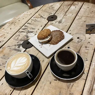 two cups of coffee on a wooden table