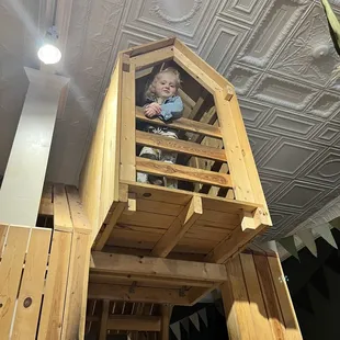 a child in a wooden house
