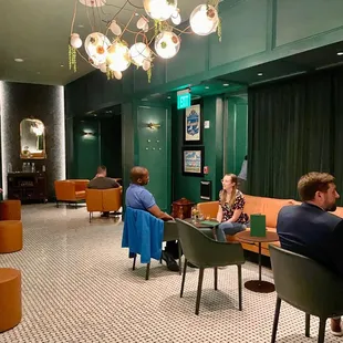 a group of people sitting in a lobby