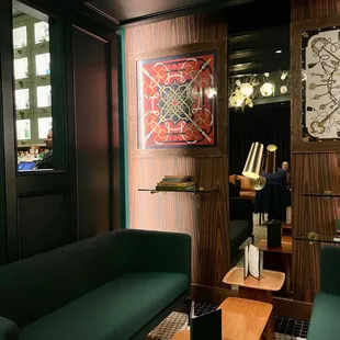 a living room with green couches and a wooden coffee table