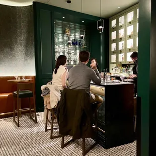 a group of people sitting at a bar