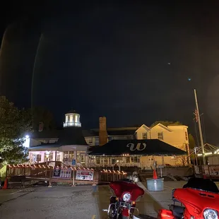 two motorcycles parked in a parking lot
