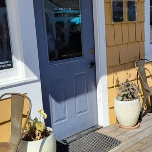 a porch with chairs and a table