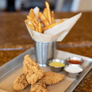 a tray of fried chicken and fries