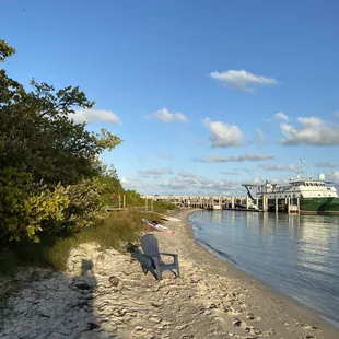 a beach with a boat in the background