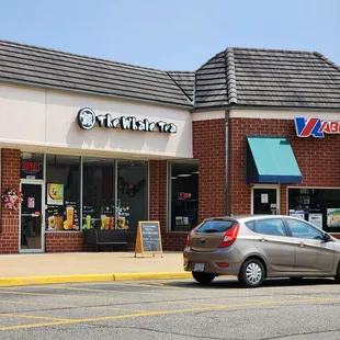 a car parked in front of a coffee shop