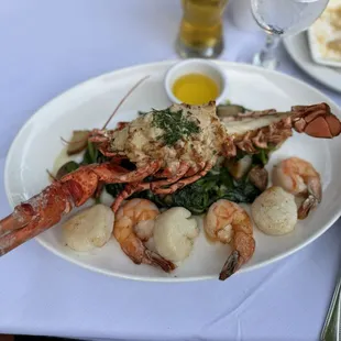 Stuffed Lobster, scallops, shrimps, potatoes and spinach
