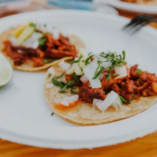 two tacos on a white plate