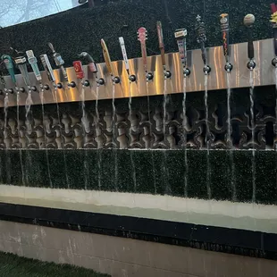 a row of beer taps on a wall