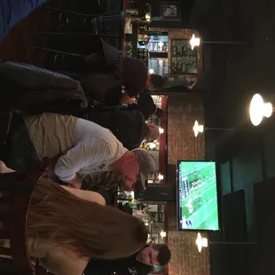 a group of people sitting at a bar