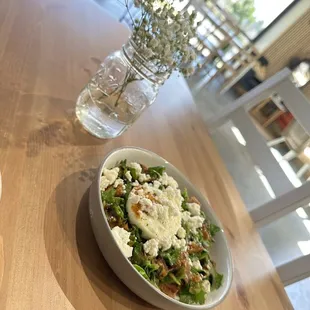 a bowl of salad and a glass of water