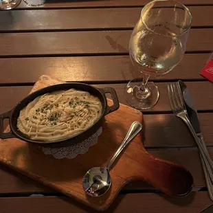 a plate of food and a glass of wine