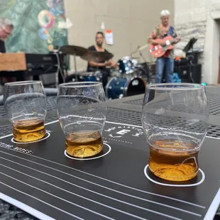 three glasses of whiskey on a table