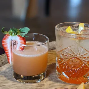 two glasses of alcohol and a platter of appetizers