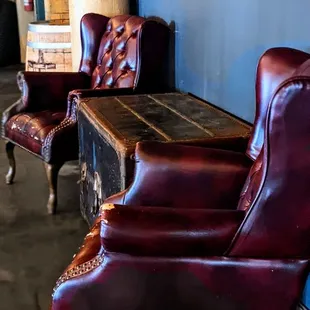 two leather chairs and a trunk