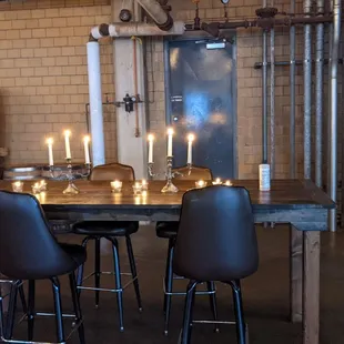 a wooden table with black chairs