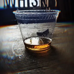 a glass of whiskey on a table
