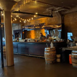 a bar with barrels and people