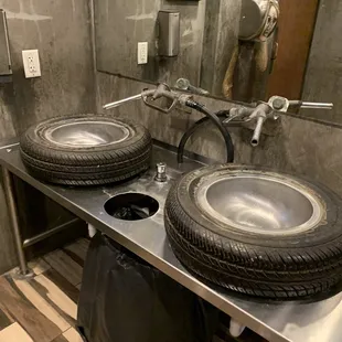 Men's restroom sinks are tires and gas pumps!