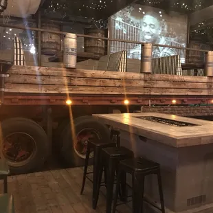 a bar with stools and a fire pit