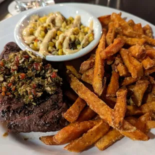 Chimichurri steak with sweet potatoes and corn salsa sides.