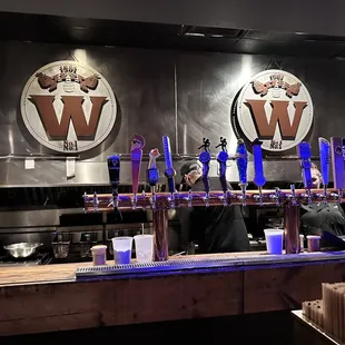 a man and a woman behind a bar