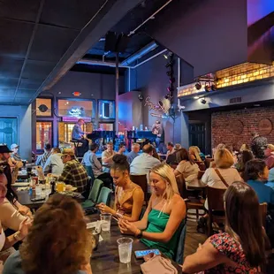 a large group of people sitting at tables