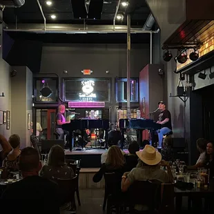 a man on stage at a bar