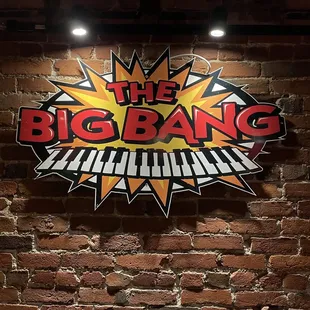 the big bang logo on a brick wall