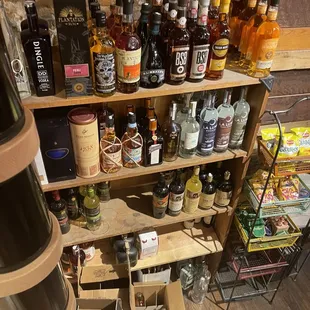 a shelf full of liquor bottles