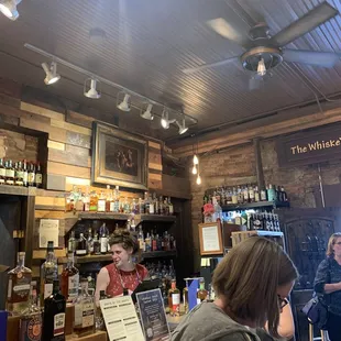 a woman sitting at a bar