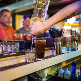 a bartender pouring a drink