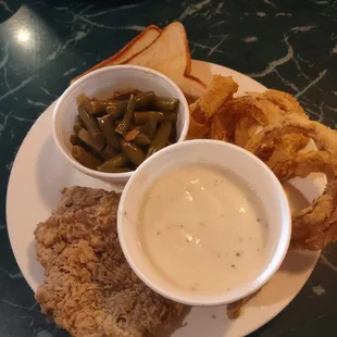 Chicken fried steak, onion rings, green beans and texas toast