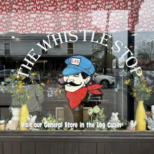 a window with a sign that says, visit our local store in the living room