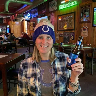 a woman holding a beer