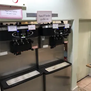 a row of frozen yogurt machines