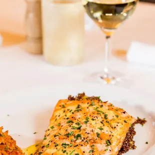 a plate of food and a glass of wine