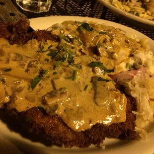 Jäger schnitzel: breaded pork chop with red wine mushroom gravy on potatoes and sauerkraut. Good 8