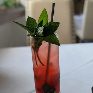 a glass with a drink and mint