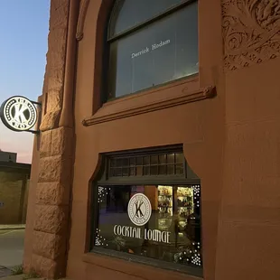 a clock in the window of a building