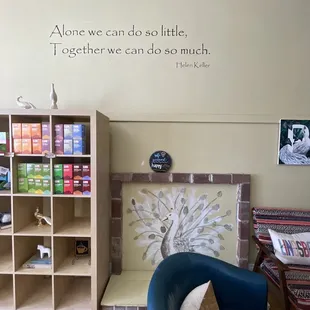 &quot;Alone we can do so little. Together we can do so much.&quot; Helen Keller quote inside white peacock coffee shop