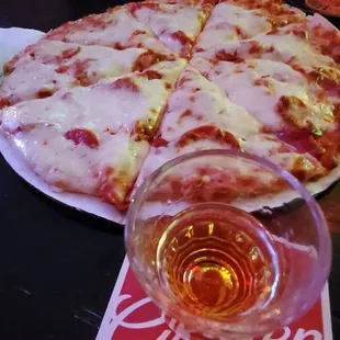 a pizza and a glass of beer