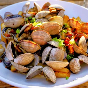 Poutine of the Sea: chowder-style gravy, steamed clams, fries, scallions, bacon ($23).