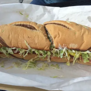 Toasted Italian super sub with lettuce, tomatoes, banana peppers, and mayo.