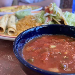 a bowl of enchilada and a plate of burritos