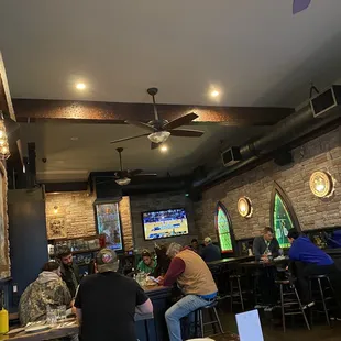 people sitting at tables in a restaurant