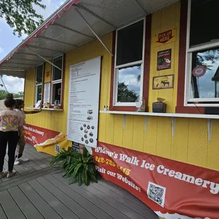 a woman standing outside of a restaurant