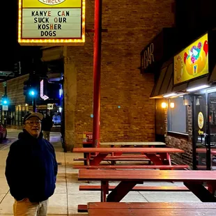 a man standing in front of a restaurant