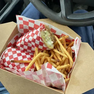 Pork BBQ with a mustard sauce and slaw and a side of fries.