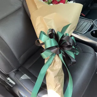 Carnations &amp; red roses wrapped for a graduation.